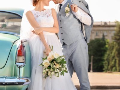 Happy wedding couple near car outdoors Happy wedding couple near car outdoors