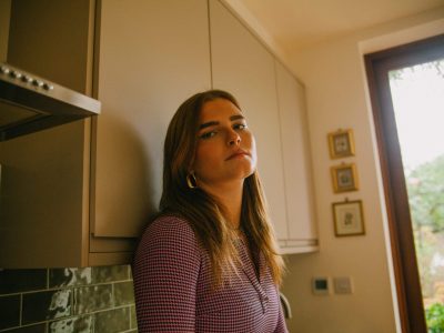 Analogue style portrait of young woman in kitchen Analogue style portrait of young woman in kitchen
